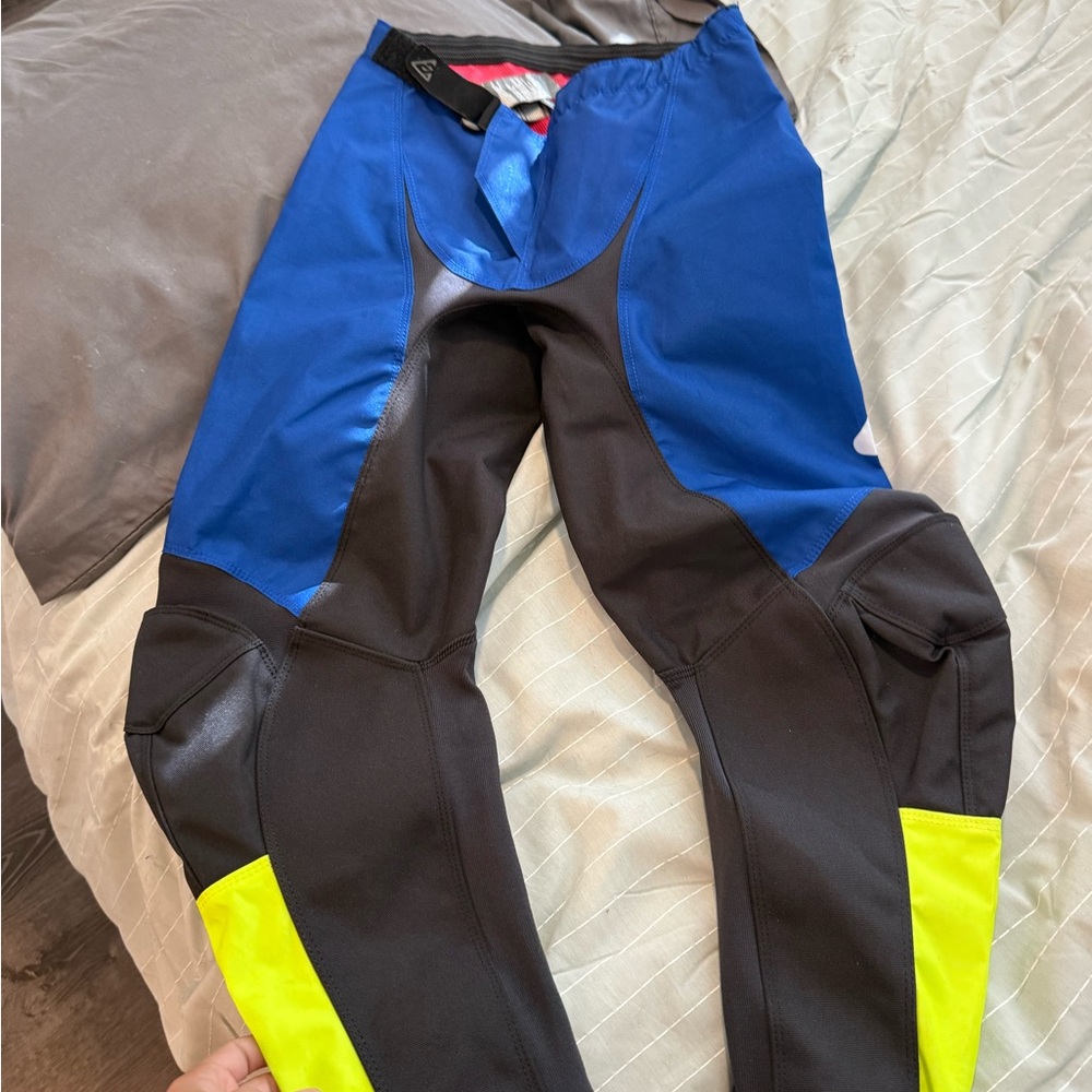 Blue and Black Athletic Pants with Yellow Accents is 28 and another 32  is new